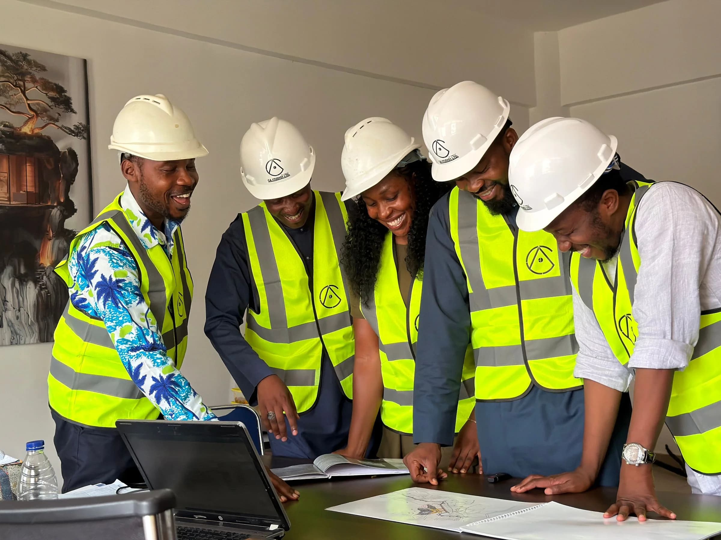 Nigerian engineering team reviewing technical plans together
