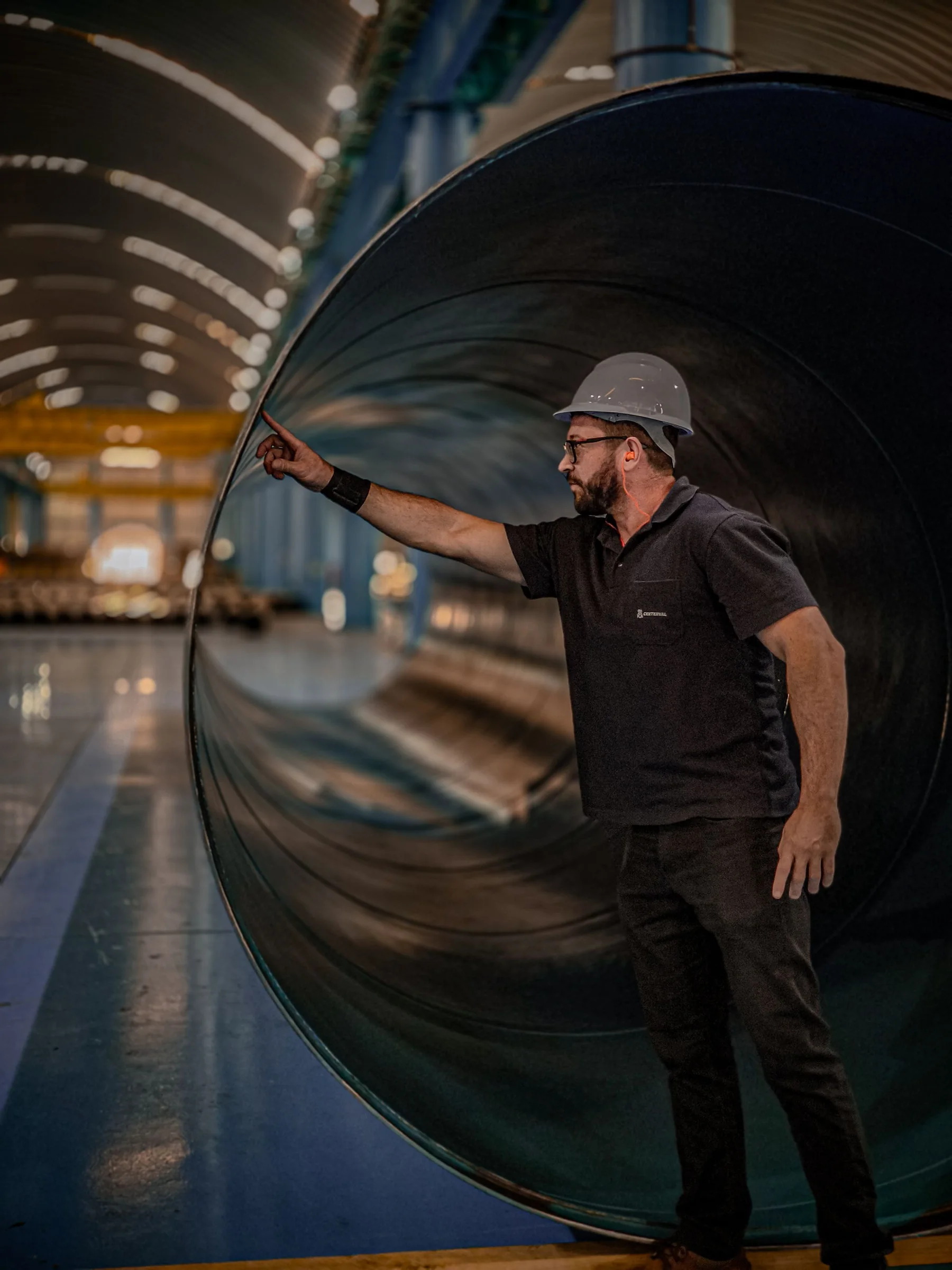 Engineer inspecting the surface of a large fabricated pipe